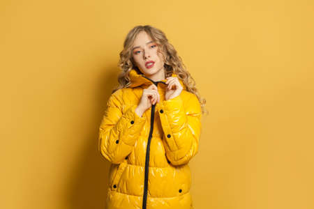 Fashion portrait of stylish model woman in yellow jacketの写真素材