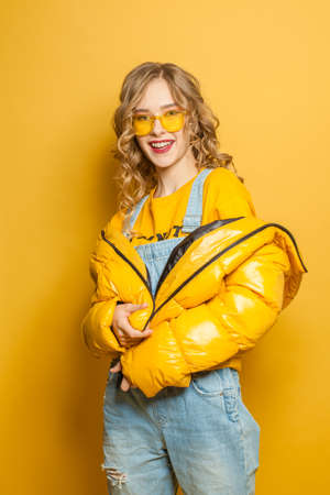 Fashion portrait of stylish model woman in yellow jacketの写真素材