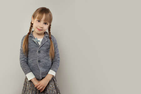Smiling student child girl on white banner backgroundの写真素材