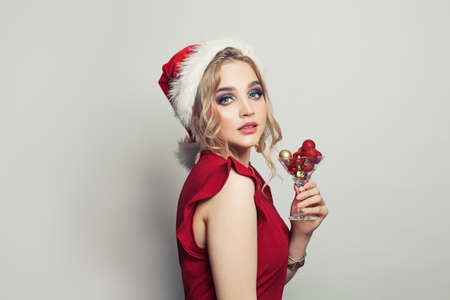 Beautiful woman Santa on white background, Christmas and New Year party portraitの写真素材