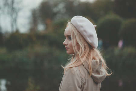 Nice autumn woman on fall nature backgroundの写真素材