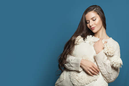 Resting woman with white pillow on blue banner backgroundの写真素材