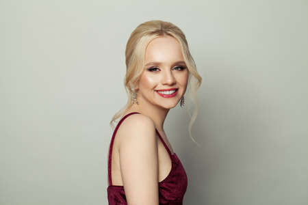 Happy young blonde woman smiling on white backgroundの写真素材