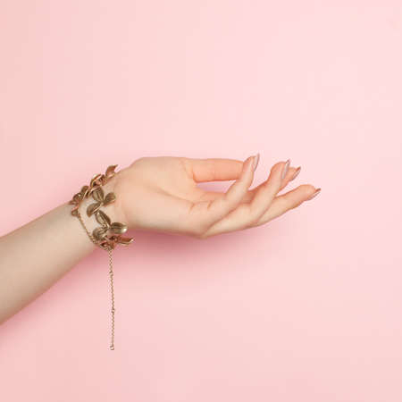 Open woman hand on pink, minimal backgroundの写真素材