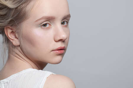 Perfect young woman face close up. Female model on white backgroundの写真素材