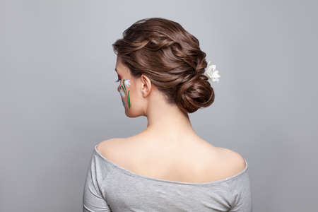 Pretty brunette woman back and head with perfect hairdo on white backgroundの写真素材