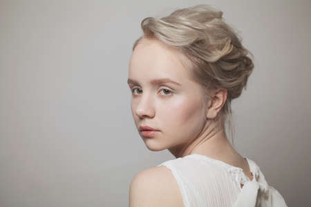 Pretty woman face with blonde hair on white background