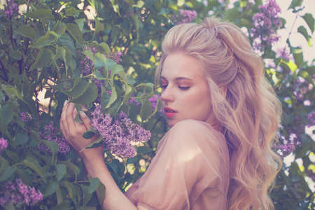 Perfect spring woman with flowers outdoorsの写真素材