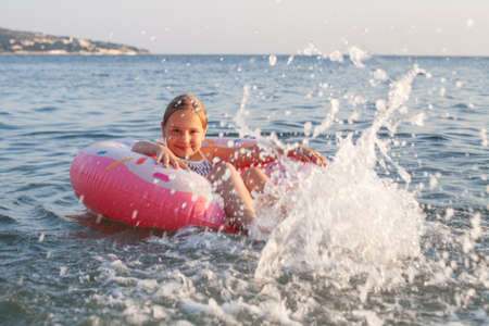 Adorable little girl at the beach during summer vacationの写真素材