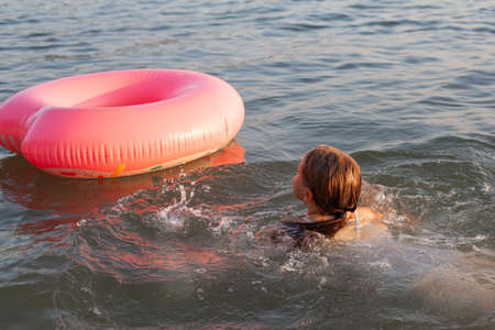Child girl learn swimming in the sea