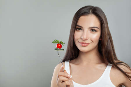 Cute young woman brunette with vegetable, healthy eating portrait