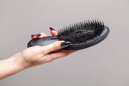 Comb and hair on gray background, hair loss and hair care conceptの写真素材