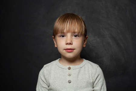 Little girl kid face on black blackboard, portraitの写真素材