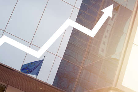 Business background with finance office bilding, rising arrow and blue EU flagの写真素材
