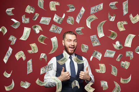 Attractive young businessman winner with American US dollar money