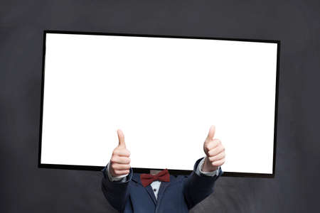 Happy boy in suit with blank empty screen display tv-head showing thumb up on black background