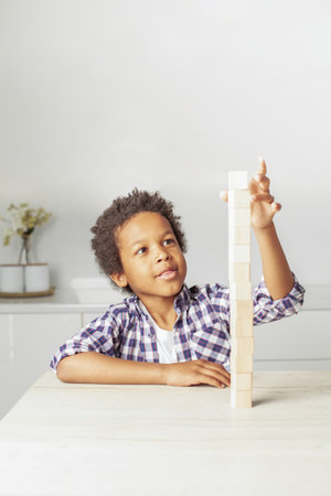 Creative kid building a block tower at homeの写真素材