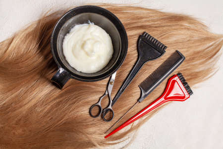 Top view of hair, scissors, comb and hair dye, beauty hair salon conceptの写真素材