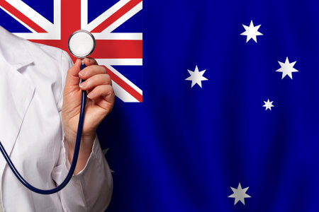 Swedish medical worker's hand with stethoscope on flag of Sweden backgroundの写真素材