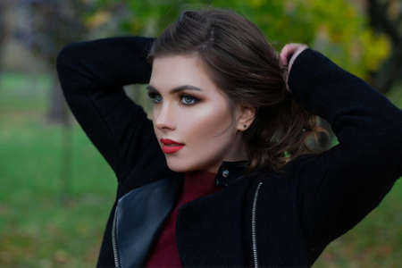 Perfect brunette woman outdoors, cute female face closeup