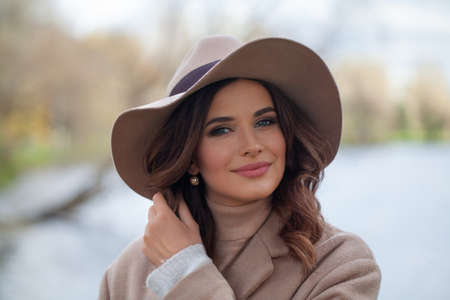 Stylish woman smiling, outdoors portrait