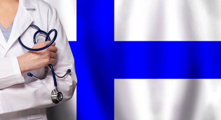 Finnish medicine and healthcare concept. Doctor close up against flag of Finland backgroundの写真素材