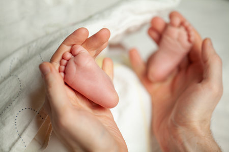 Baby's feet in daddy's hands
