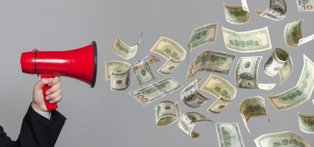 Person with a loudspeaker say moneyの写真素材