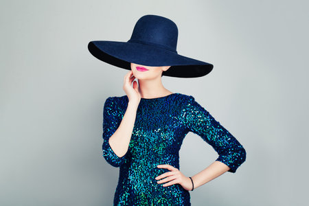 Glamorous Woman in Glitter Fashionable Dress and wide broad brim hatの写真素材