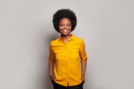 Joyful female model posing against white studio wall backgroundの写真素材