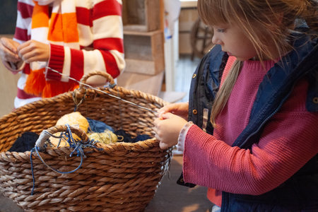 Child girl with thread in handsの写真素材