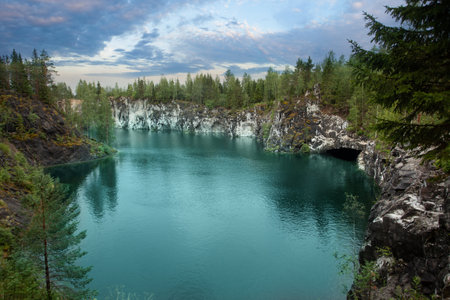Cute landscape of cloudy sky, green forest and beautiful mountain riverの写真素材