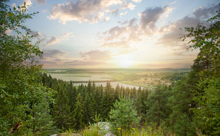 Landscape of bright sunset, green forest and mountain river