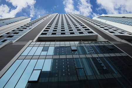 Modern skyscarper of steel and glass on the background of sky
