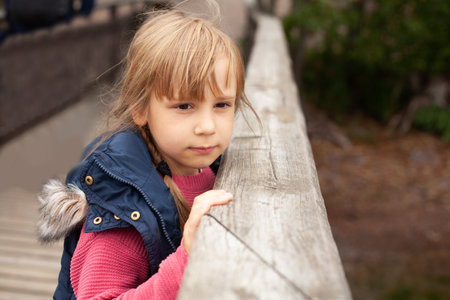 Portrait of child girl in the park in autumn