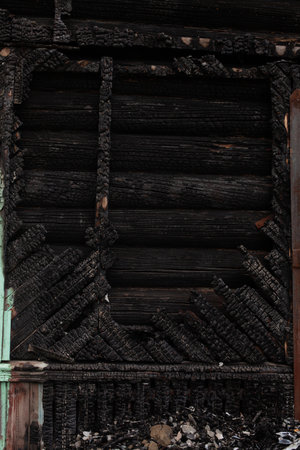 Completely burned black wooden houseの写真素材