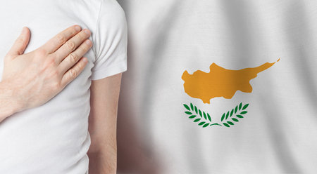 Cyprus person with hand on heart on the background of Cyprus flag. Patriotism, country, national pride conceptの写真素材