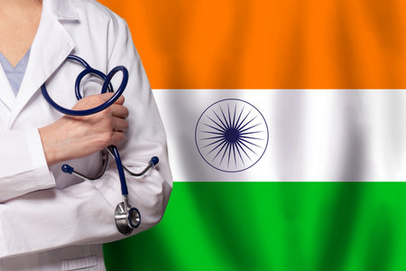 Indian medicine and healthcare concept. Doctor close up against flag of India backgroundの写真素材