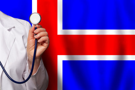 Icelandic doctor's hand with stethoscope on the background of flag of Iceland Medicine, clinic, practitioner, healthcareの写真素材