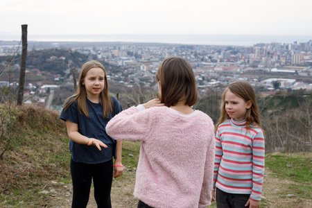 Joyful children little girls playing together outdoorの写真素材