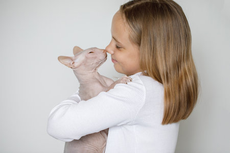 Portrait of cute child girl with kitten on white backgroundの写真素材