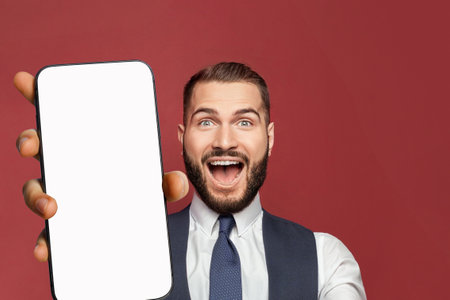Winner man holds smartphone with blank empty white screen display for new Application or mobile...