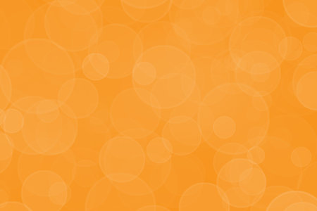 Bright orange bokeh background. Birthday, Christmas or New Year holidays template. Abstract glitter defocused blinking bubble and sparkle.の写真素材