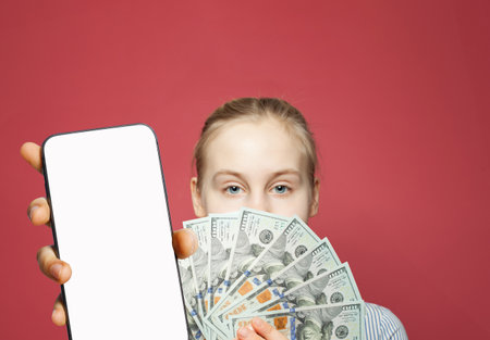 Young female model showing smartphone with blank empty white screen display and money cash us...