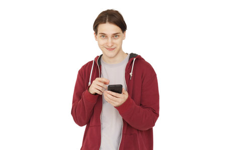 Happy guy smiling while using mobile phone isolated over white background