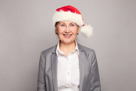 Senior business woman in Santa hat, Christmas portraitの写真素材