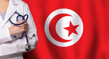 Tunisian medicine and healthcare concept. Doctor close up against flag of Tunisia backgroundの写真素材