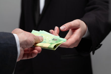 Money cash euro banknote in human hand. Deal, salary and credit concept