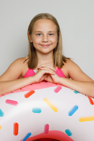 Joyful happy child girl with inflatable ring swimming float closeup. Summer, vacation and leisure...
