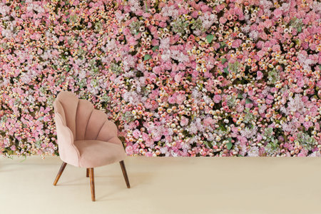 Pink furniture and interior home decoration background. Velvet velor armchair against floral wallの写真素材